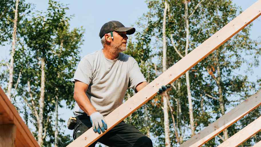 A professional installing trusses on a construction site